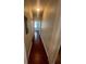 Hallway with hardwood floors and neutral walls at 18001 Richmond Place Dr # 425, Tampa, FL 33647