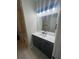 Modern bathroom with gray vanity and white countertop at 18001 Richmond Place Dr # 425, Tampa, FL 33647