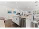 Kitchen island with stainless steel dishwasher, marble countertops and views of the dining area at 2517 4Th S Ave, St Petersburg, FL 33712