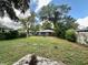 Large backyard with a view of the house at 3013 E Powhatan Ave, Tampa, FL 33610