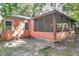 Side exterior view showcasing the screened porch at 3310 W Palmira Ave, Tampa, FL 33629