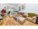 Spacious living room with light beige sectional sofa and wood floors at 4234 Chesterfield Cir, Palm Harbor, FL 34683