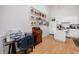 Kitchen with white cabinetry, island, and wood flooring at 4234 Chesterfield Cir, Palm Harbor, FL 34683