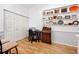 Home office with built-in shelving, desk, and vintage rolltop desk at 4234 Chesterfield Cir, Palm Harbor, FL 34683