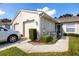 Villa with two-car garage and manicured lawn at 4234 Chesterfield Cir, Palm Harbor, FL 34683