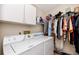 Laundry room with washer, dryer, shelving, and ample closet space at 4234 Chesterfield Cir, Palm Harbor, FL 34683