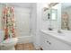 Clean bathroom with floral shower curtain, single sink vanity and tub at 4234 Chesterfield Cir, Palm Harbor, FL 34683