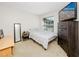 Cozy bedroom with a dresser, full-size bed, and large window at 4234 Chesterfield Cir, Palm Harbor, FL 34683