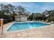 Community pool with lounge chairs and a pool house at 4234 Chesterfield Cir, Palm Harbor, FL 34683