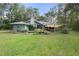 Expansive backyard with mature trees and landscaping offers ample space and privacy at 5143 Culbreath Rd, Brooksville, FL 34601