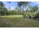 Expansive backyard with mature trees offers peaceful space and a patio area at 5143 Culbreath Rd, Brooksville, FL 34601