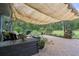 Backyard patio has lounge seating, BBQ grill, and peaceful wooded backdrop at 5143 Culbreath Rd, Brooksville, FL 34601