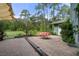 Lush backyard area featuring a patio, exterior home view and mature trees at 5143 Culbreath Rd, Brooksville, FL 34601