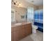 Bathroom with granite countertops, large mirror and shower-tub combination with a curtain at 5143 Culbreath Rd, Brooksville, FL 34601