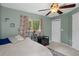 Bedroom with a ceiling fan and light neutral color scheme with a view to backyard at 5143 Culbreath Rd, Brooksville, FL 34601