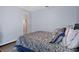 Bedroom features a patterned comforter with large windows and white doors at 5143 Culbreath Rd, Brooksville, FL 34601