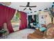 Versatile bedroom featuring unique decor, comfortable seating, and a view of the outdoors at 5143 Culbreath Rd, Brooksville, FL 34601
