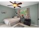 Bedroom with a ceiling fan and light neutral color scheme with view to backyard at 5143 Culbreath Rd, Brooksville, FL 34601
