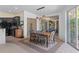 View of dining room area with sliding glass doors to outdoor area and modern light fixtures at 5143 Culbreath Rd, Brooksville, FL 34601