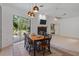 Bright dining room with modern lighting, fireplace, and sliding glass doors to the patio at 5143 Culbreath Rd, Brooksville, FL 34601