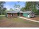 Inviting home exterior featuring a well-maintained yard, brick accents, and a walkway to the entrance at 5143 Culbreath Rd, Brooksville, FL 34601