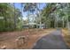Beautiful home surrounded by mature trees, featuring lush greenery and a long paved driveway at 5143 Culbreath Rd, Brooksville, FL 34601