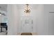 Grand foyer featuring chandelier lighting and a decorative front door at 5143 Culbreath Rd, Brooksville, FL 34601
