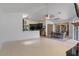 Open-concept living room and kitchen area with light wood floors and neutral tones at 5143 Culbreath Rd, Brooksville, FL 34601