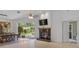 View of living room with fireplace, sliding doors to the backyard, and access to another room at 5143 Culbreath Rd, Brooksville, FL 34601