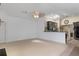 Spacious living room with a ceiling fan and skylight next to kitchen at 5143 Culbreath Rd, Brooksville, FL 34601