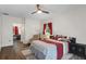 Spacious main bedroom boasts wood floors, ceiling fan, and access to an ensuite bathroom at 5143 Culbreath Rd, Brooksville, FL 34601