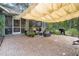 Enjoy the shade on this backyard patio with seating, grill, and lush foliage at 5143 Culbreath Rd, Brooksville, FL 34601