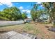 Large backyard with green grass and mature trees, offering space for outdoor enjoyment and recreation at 5721 12Th S Ave, Gulfport, FL 33707