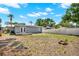 Spacious backyard featuring a well-maintained lawn, fencing, and access to the house with a wooden deck at 5721 12Th S Ave, Gulfport, FL 33707