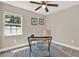 Bright home office space with a sleek desk, accent chair, and natural light coming from the window at 5721 12Th S Ave, Gulfport, FL 33707