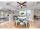 Dining room features a view of the living room, ceiling fan and blue chairs at 5721 12Th S Ave, Gulfport, FL 33707