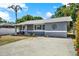 Charming single-story home with a well-manicured lawn, a modern gray exterior, and a welcoming front porch at 5721 12Th S Ave, Gulfport, FL 33707