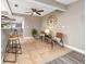 Open living room features tile flooring, ceiling fan and seating area with decorative wall clock at 5721 12Th S Ave, Gulfport, FL 33707