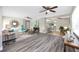 Open-concept living room featuring luxury vinyl flooring, modern ceiling fans, and a seamless flow to the kitchen at 5721 12Th S Ave, Gulfport, FL 33707