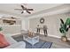 Open-concept living room with neutral paint, modern furniture, and decorative accents, flowing into the kitchen at 5721 12Th S Ave, Gulfport, FL 33707
