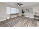 Bright and spacious living room showcasing vinyl plank flooring, a large window, and neutral wall color at 5721 12Th S Ave, Gulfport, FL 33707