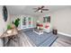 Inviting living room featuring wood-look flooring, stylish rug, modern decor, and sliding doors to the backyard at 5721 12Th S Ave, Gulfport, FL 33707