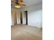 Spacious bedroom with neutral carpet, ceiling fan, and multiple closet doors at 8550 Trail Wind Dr, Tampa, FL 33647