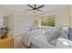 Cozy bedroom with a comfortable bed, ceiling fan, and window view at 9605 Woodbay Dr, Tampa, FL 33626