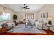 Living room featuring hardwood floors, a ceiling fan, and comfortable seating at 9605 Woodbay Dr, Tampa, FL 33626