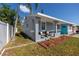 Newly renovated home with gray exterior and turquoise door at 5721 12Th S Ave, Gulfport, FL 33707