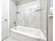 Clean bathroom with a white bathtub and marble tile at 5721 12Th S Ave, Gulfport, FL 33707
