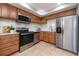 Modern kitchen featuring stainless steel appliances and wood cabinetry at 5721 12Th S Ave, Gulfport, FL 33707