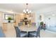 Charming dining area with round table, four chairs, and a chandelier at 907 La Jolla Ave, Sun City Center, FL 33573