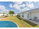 Landscaped backyard with grassy lawn and blue rock feature at 907 La Jolla Ave, Sun City Center, FL 33573